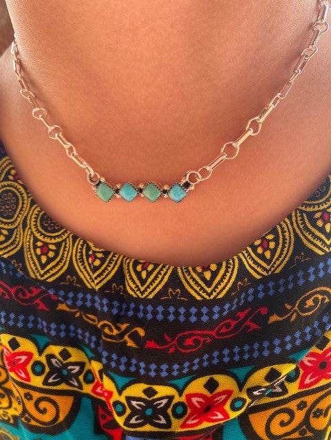 Cute little 4 stone bar necklace. Featuring Kingman turquoise, sterling silver, and created by Navajo artist Jerome Lee